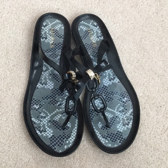 Guess Shoes - Guess Black and gold bedazzled flip flops!